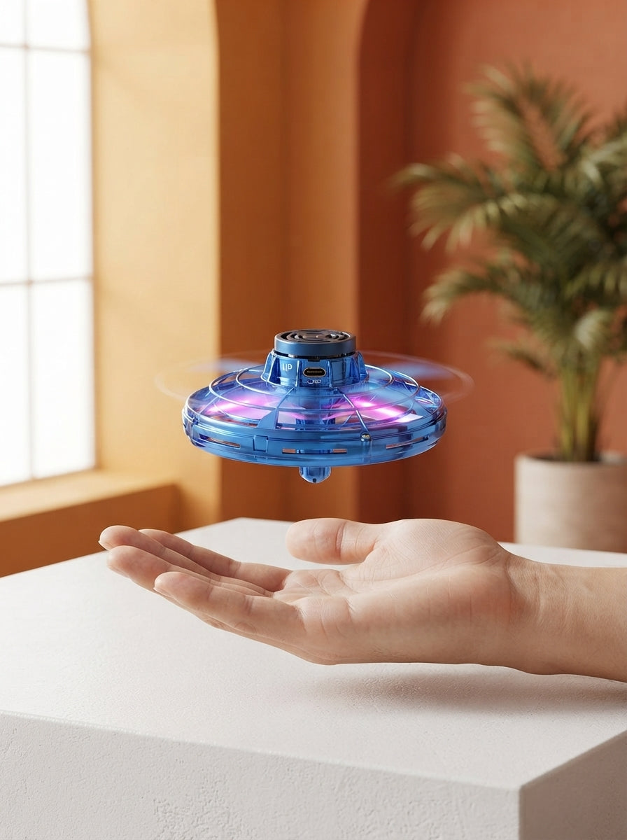 A miniature UFO drone spinner hovering above a person's hand in a bright, modern studio with warm terracotta and amber decor.